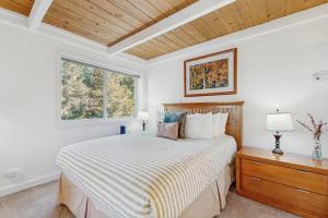 ein weißes Schlafzimmer mit einem Bett und einem Fenster in der Unterkunft Atelier 1015 in Sun Valley