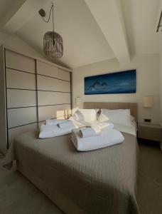a bedroom with a large bed with two white pillows at Brand new Big Blue in Jelsa