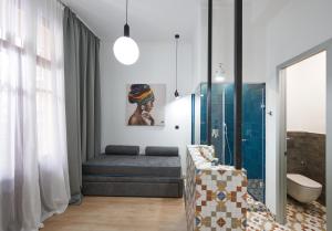 a bathroom with a bed and a sink in a room at The Maroon Bottle Hotel in Thessaloniki +85 photos