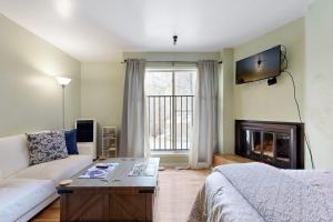 a living room with a couch and a fireplace at Elkhorn Angani 54 in Sun Valley