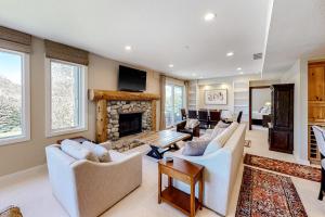 a living room with white furniture and a fireplace at Ketchum Bliss in Ketchum