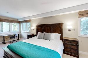 a bedroom with a large bed with a desk and windows at Ketchum Bliss in Ketchum +65 photos