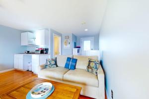 a living room with a couch and a table at Little Gem at Hampton Beach in Hampton