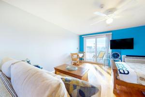 a living room with a couch and a flat screen tv at Little Gem at Hampton Beach in Hampton