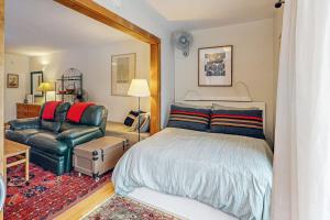 a bedroom with a bed and a couch and a chair at Snow Run Studio in Ketchum