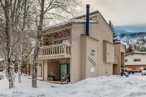 a large building with a balcony in the snow at Snow Run Studio in Ketchum
