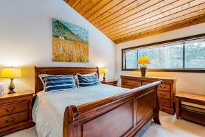 a bedroom with a large bed and two windows at Bridgepoint Condo on Trail Creek in Ketchum