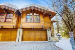 a wooden house with two garage doors at Luxury Mountain Townhome in Ketchum