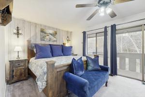 a bedroom with a bed with blue pillows and a blue chair at Downtown Creekside Getaway in Ketchum