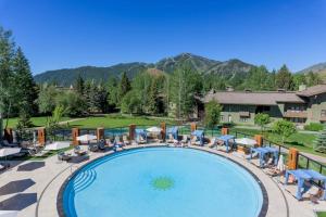 a pool at a resort with mountains in the background at Delightful Atelier Getaway in Sun Valley