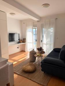a living room with a couch and a tv at Villa Knez in Trogir