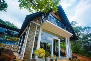 a house with a large window on the side of it at Nixon Anroos in Kavudupelella