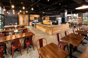 a restaurant with wooden tables and chairs and a counter at Hotel 1080 in Brooklyn