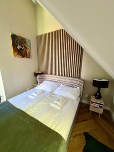 a bedroom with a bed with white sheets at Górski Błękit in Szklarska Poręba +23 photos