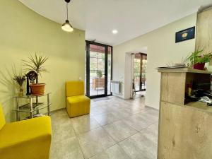 a living room with yellow furniture and a yellow chair at Merien hotel in Yerevan