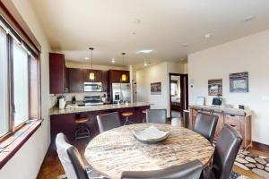 a kitchen and dining room with a table and chairs at Blue River Condo Unit 203 in Silverthorne