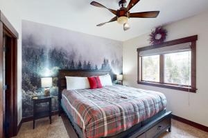 a bedroom with a bed and a ceiling fan at Blue River Condo Unit 203 in Silverthorne