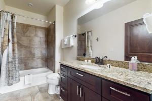 a bathroom with a sink and a toilet and a shower at Blue River Condo Unit 203 in Silverthorne +60 photos