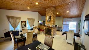 a living room with a table and chairs and a fireplace at Kliprand Guest House in Springbok +201 photos