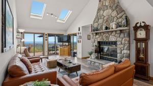 a living room with couches and a stone fireplace at Stone Ridge by AvantStay in Albrightsville