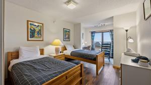 a bedroom with two beds and a balcony at Stone Ridge by AvantStay in Albrightsville