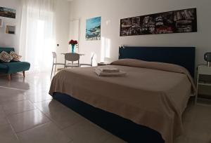 a bedroom with a bed and a table and a chair at ROUTE 96 Guest House in Modugno