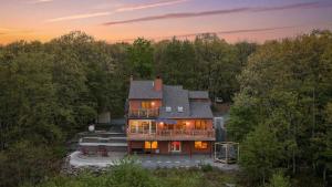 an aerial view of a house in the woods at Stone Ridge by AvantStay in Albrightsville