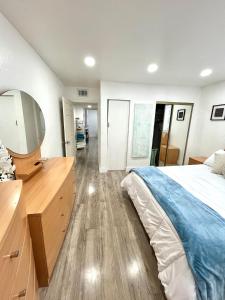 a bedroom with a bed and a tv on a dresser at Sanctuary Retreat Florida HardRock in Hollywood