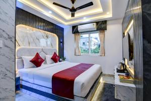 a bedroom with a large bed with red pillows at Hotel Aarnika Villa in New Town +34 photos
