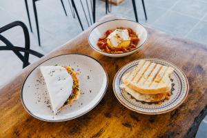two plates of food on a wooden table at Vila Tuga in Prea