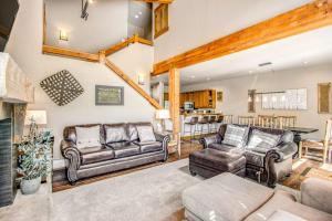 a living room with two couches and a fireplace at Alpine Holidays Ski Tip in Keystone