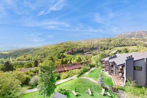 an aerial view of a resort building with a hill in the background at Snowmas Village A4 in Snowmass Village