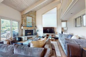a living room with two couches and a television at Snowmas Village A4 in Snowmass Village