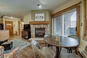 a living room with a table and a fireplace at Keystone Condo 8380 in Keystone