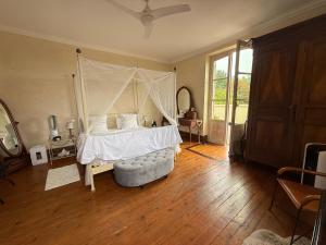 a bedroom with a bed with a canopy at En bord de rivière in Casseneuil +66 photos