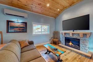 a living room with a couch and a fireplace at Riverbank Place in Ogunquit