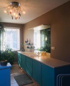 a bathroom with a sink and a large mirror at chambre dans les bois in Namur
