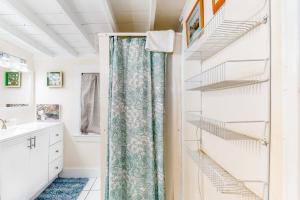 a bathroom with a walk in closet with a shower curtain at Riverbank Place in Ogunquit +26 photos