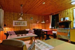 a living room with a couch and a table at Holiday Home Långberget in Sysslebäck