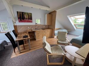 a kitchen with a sink and a table and chairs at Kasztanowe Wrota in Kosewo