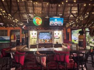 a bar in a restaurant with chairs and lights at Hacienda Puerta del Cielo Eco Lodge & Spa in Masaya