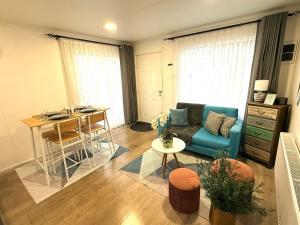 a living room with a couch and a table at Departamento Pinela in Punta Arenas