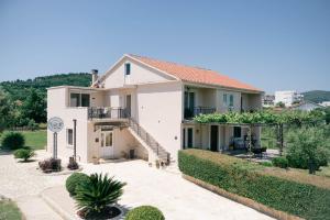 a white house with a staircase and plants at La Hacienda in Ulcinj