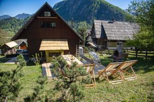a group of chairs in front of a barn at Chalet Guapa in Bohinj