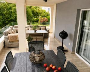 a patio with a table and chairs and a couch at LUXURY MANDRE HOUSE in Mandre