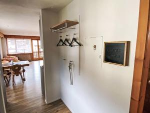 a room with a white wall with a sign on it at Apartment Wohnung Curtins by Interhome in Pontresina