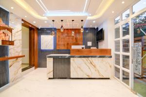 a kitchen with marble countertops and glass doors at Hotel Aarnika Villa in New Town