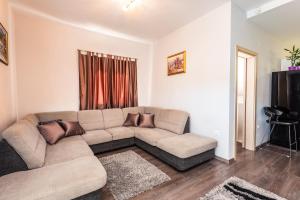 a living room with a couch and a television at Margaritum Blace - Seaview Apartment with Balcony in Blace