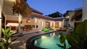 a villa with a swimming pool in a yard at Golden Villa in Gili Trawangan