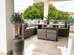 a patio with a couch and a table with plants at LUXURY MANDRE HOUSE in Mandre +76 photos